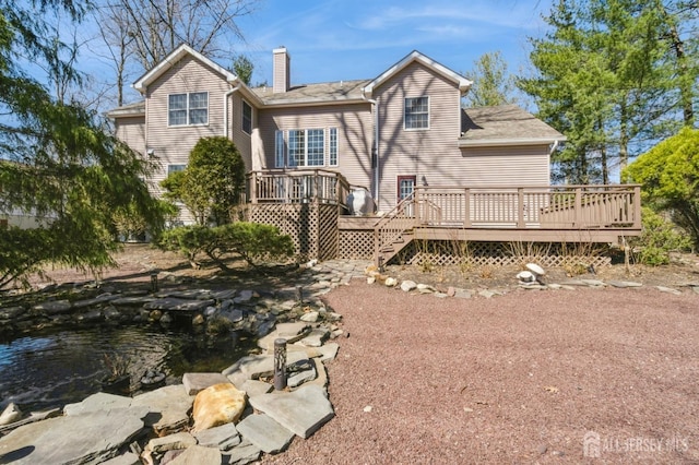 rear view of house featuring a deck and a chimney