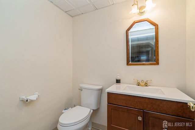 half bathroom featuring toilet and vanity