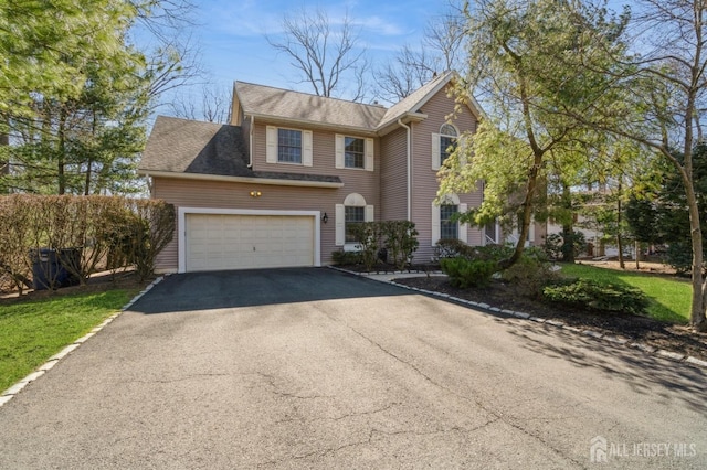 view of front of home with a garage and driveway