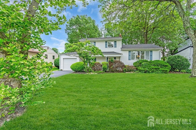3 Topaz Ln, Iselin, NJ 08830 - split level home with driveway, a front yard, a garage, and a chimney