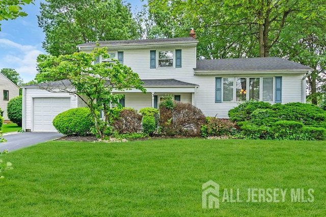 3 Topaz Ln, Iselin, NJ 08830 - tri-level home with a chimney, a front yard, asphalt driveway, and a garage