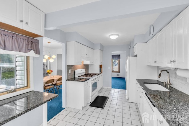 3 Topaz Ln, Iselin, NJ 08830 - kitchen featuring white appliances, light tile patterned flooring, white cabinetry, decorative backsplash, and a chandelier