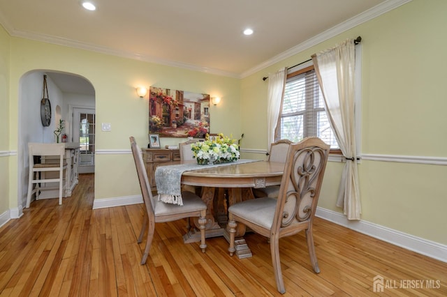 1156 Kline Pl, Rahway, NJ 07065 - dining area with light wood-style floors, crown molding, arched walkways, and recessed lighting