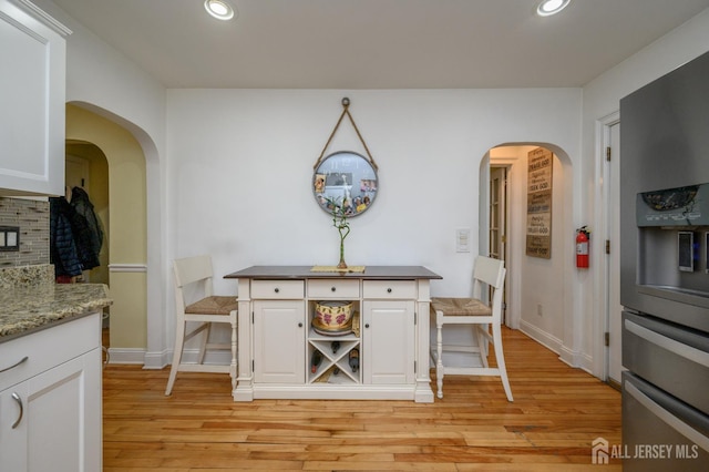1156 Kline Pl, Rahway, NJ 07065 - dining space featuring light wood-style floors, recessed lighting, and arched walkways