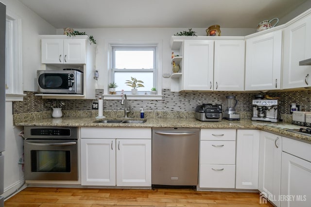 1156 Kline Pl, Rahway, NJ 07065 - kitchen featuring stainless steel appliances, white cabinets, decorative backsplash, and light stone counters