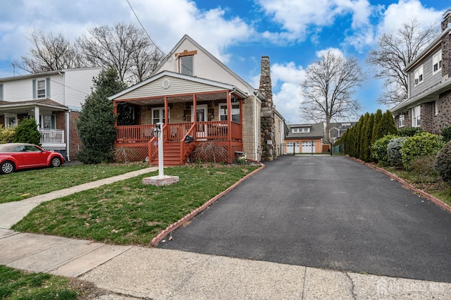 1156 Kline Pl, Rahway, NJ 07065 - bungalow-style home featuring a porch, a chimney, and a front lawn