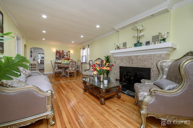 1156 Kline Pl, Rahway, NJ 07065 - living room featuring arched walkways, ornamental molding, wood finished floors, recessed lighting, and a glass covered fireplace