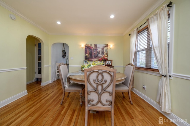 1156 Kline Pl, Rahway, NJ 07065 - dining space with arched walkways, light wood-style floors, ornamental molding, and recessed lighting