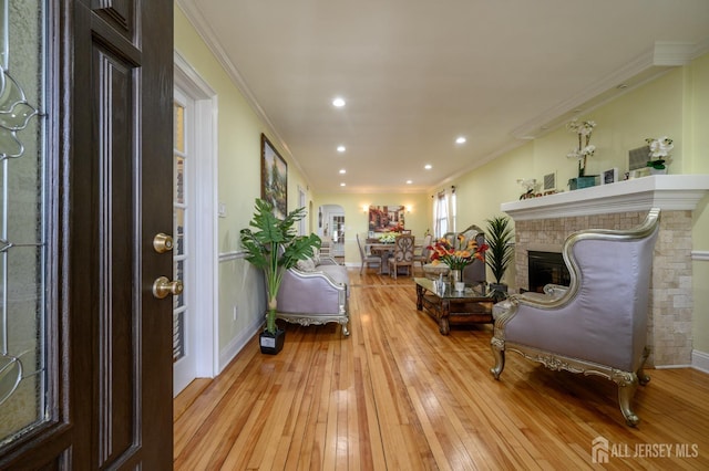 1156 Kline Pl, Rahway, NJ 07065 - entryway featuring light wood finished floors, ornamental molding, arched walkways, a glass covered fireplace, and recessed lighting