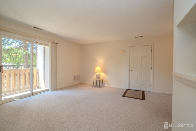 spare room featuring carpet flooring and baseboards