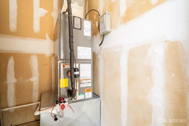 utility room featuring heating unit