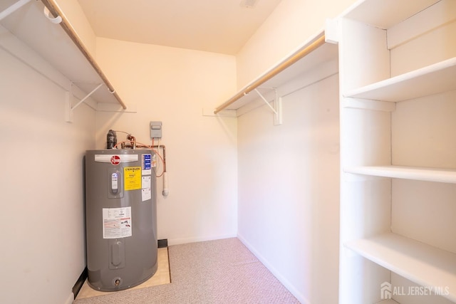 utility room with electric water heater