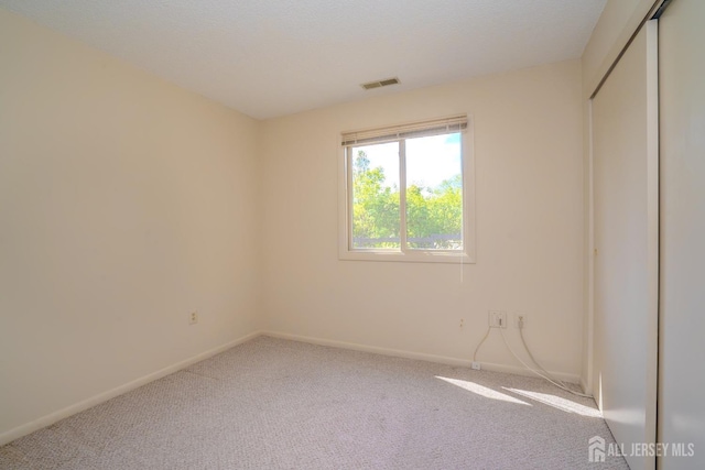 carpeted spare room with baseboards