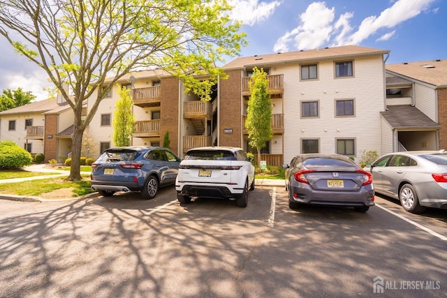 view of property featuring uncovered parking