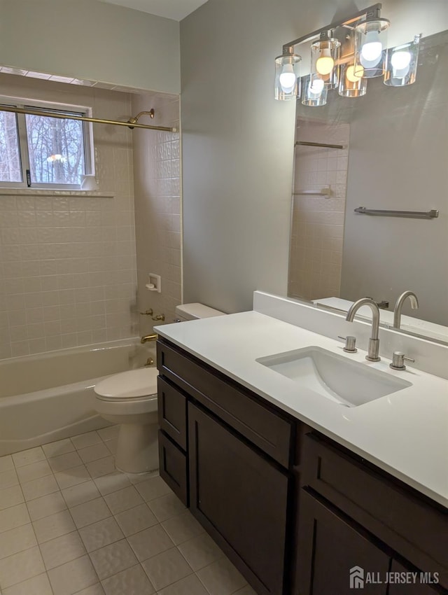 bathroom with tub / shower combination, toilet, vanity, and tile patterned flooring