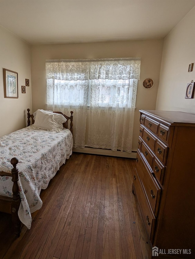 bedroom with dark wood-style flooring