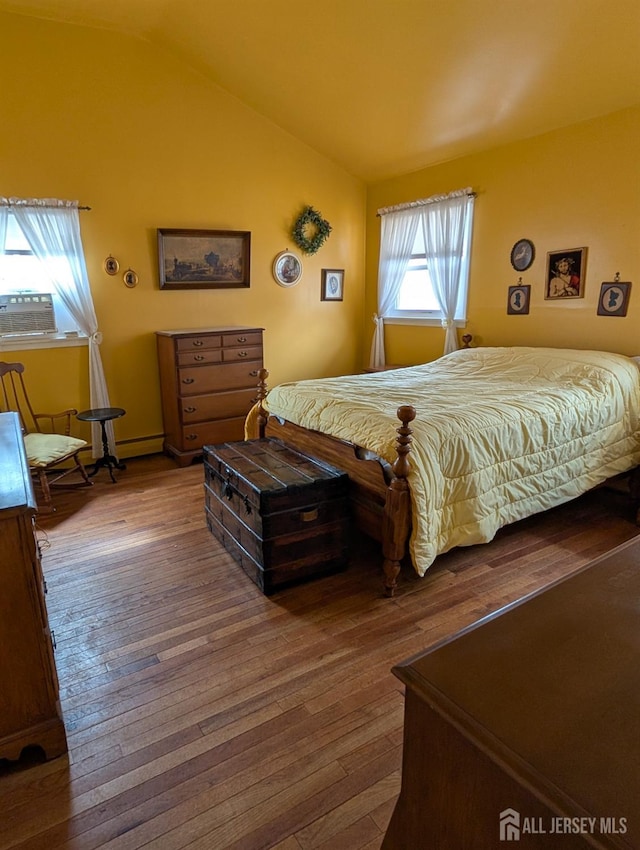 bedroom with lofted ceiling and hardwood / wood-style floors