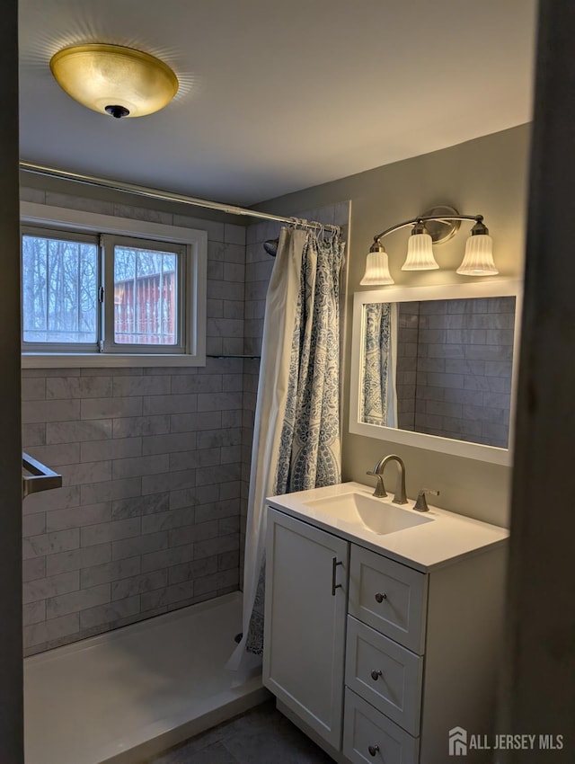 bathroom with a stall shower and vanity