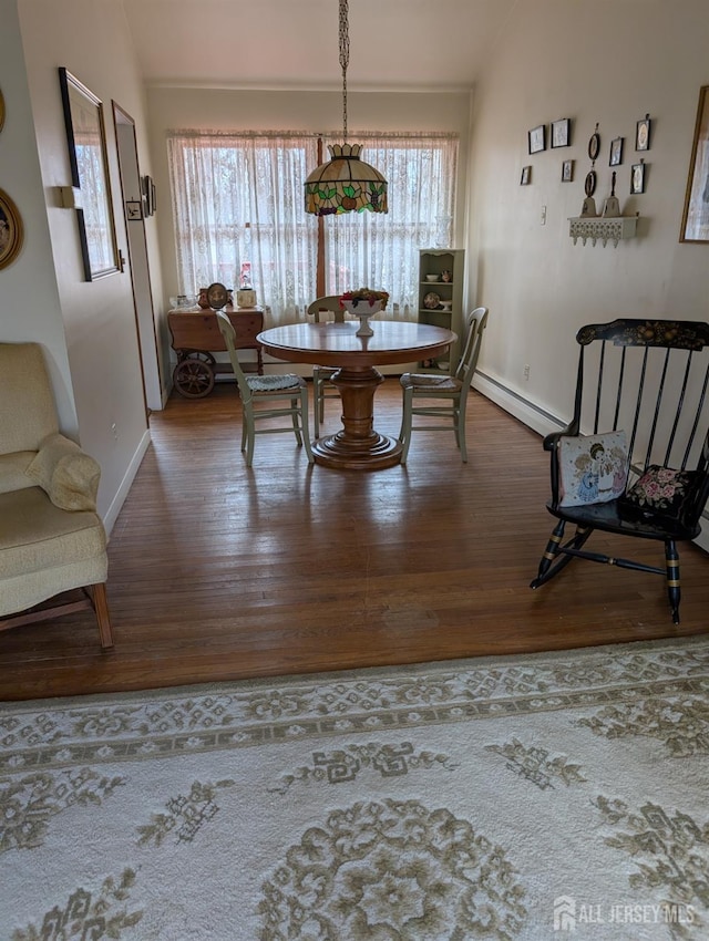 dining area featuring lofted ceiling, wood finished floors, and a wealth of natural light