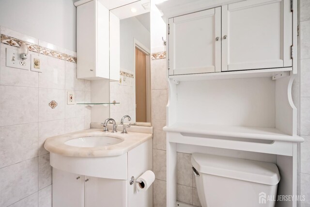 44 Frost Ave, East Brunswick, NJ 08816 - bathroom with tile walls, vanity, and toilet