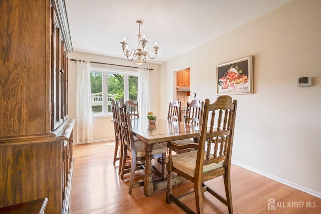 44 Frost Ave, East Brunswick, NJ 08816 - dining area featuring a chandelier, light wood-style flooring, and baseboards