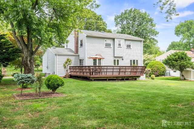 44 Frost Ave, East Brunswick, NJ 08816 - rear view of house with a wooden deck, a lawn, and central AC unit