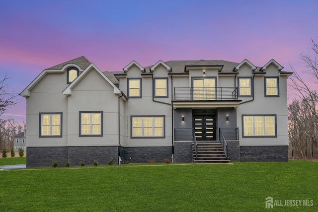 131-B Dutch Rd, East Brunswick, NJ 08816 - view of front facade with a balcony, stucco siding, and a yard