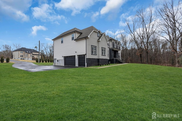 131-B Dutch Rd, East Brunswick, NJ 08816 - view of home's exterior with driveway, an attached garage, a yard, and a balcony