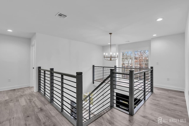 131-B Dutch Rd, East Brunswick, NJ 08816 - corridor with an upstairs landing, a chandelier, recessed lighting, wood finished floors, and baseboards