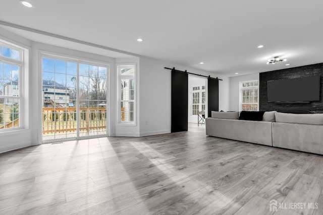 131-B Dutch Rd, East Brunswick, NJ 08816 - living room with a barn door, recessed lighting, wood finished floors, and baseboards