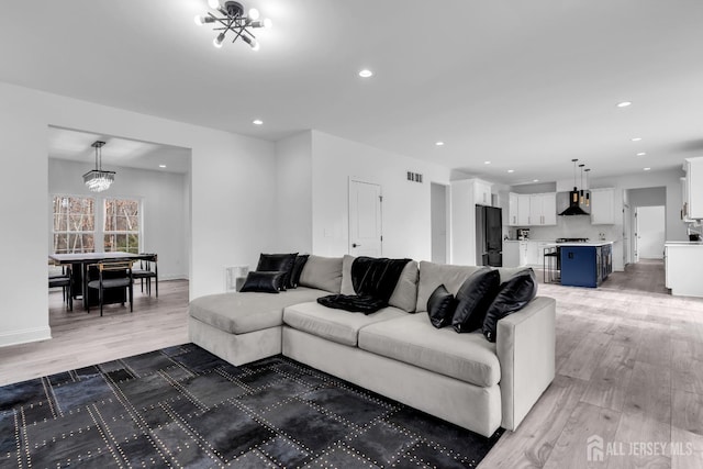 131-B Dutch Rd, East Brunswick, NJ 08816 - living room featuring light wood-style floors, a chandelier, recessed lighting, and baseboards