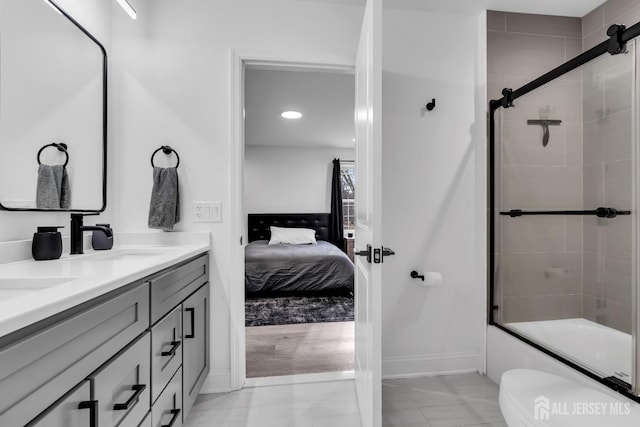131-B Dutch Rd, East Brunswick, NJ 08816 - full bath featuring marble finish floors, toilet, baseboards, bath / shower combo with glass door, and double vanity