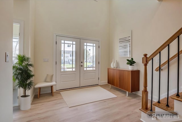 90 Hancock Rd, Piscataway, NJ 08854 - foyer entrance featuring a towering ceiling, light wood finished floors, stairs, and french doors
