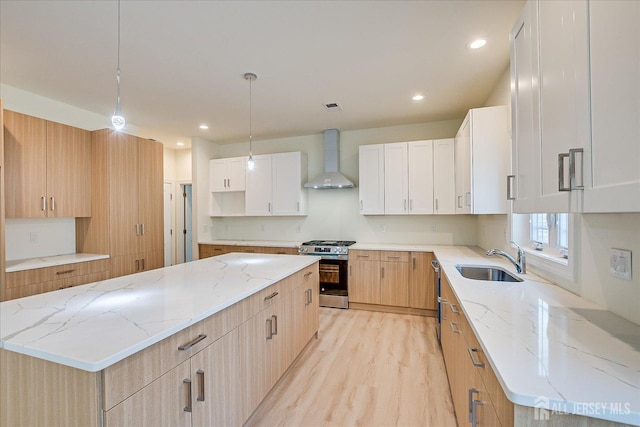 90 Hancock Rd, Piscataway, NJ 08854 - kitchen featuring stainless steel gas range, wall chimney exhaust hood, light wood finished floors, a center island, and light stone counters