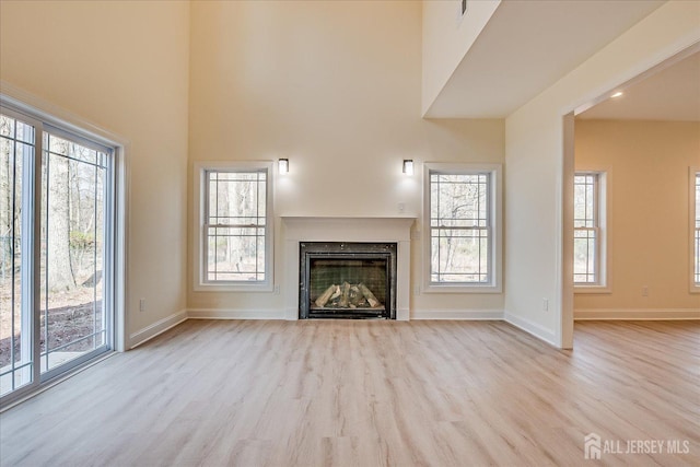 90 Hancock Rd, Piscataway, NJ 08854 - unfurnished living room with wood finished floors, a fireplace, and plenty of natural light