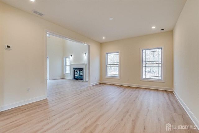 90 Hancock Rd, Piscataway, NJ 08854 - unfurnished living room with light wood finished floors, recessed lighting, and a glass covered fireplace
