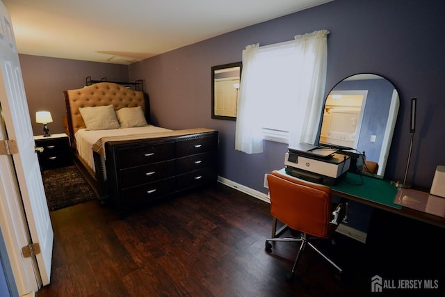 bedroom with dark hardwood / wood-style floors