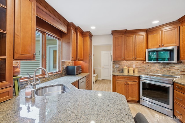 6 Steven Rd, South Brunswick, NJ 08824 - kitchen with appliances with stainless steel finishes, light stone counters, brown cabinetry, tasteful backsplash, and recessed lighting