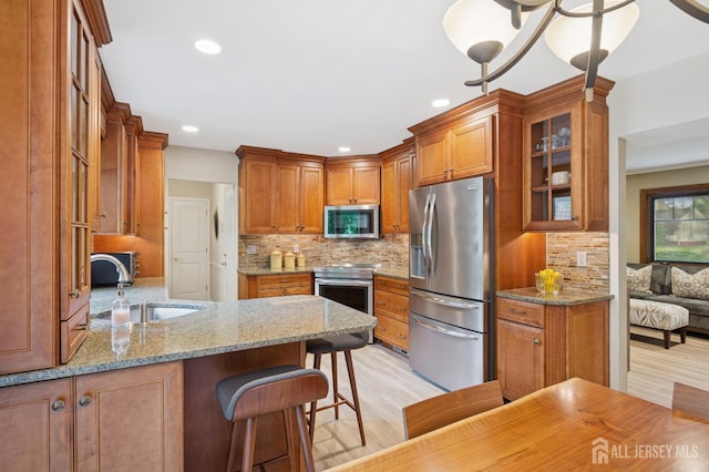 6 Steven Rd, South Brunswick, NJ 08824 - kitchen featuring appliances with stainless steel finishes, light wood-style floors, brown cabinets, and recessed lighting