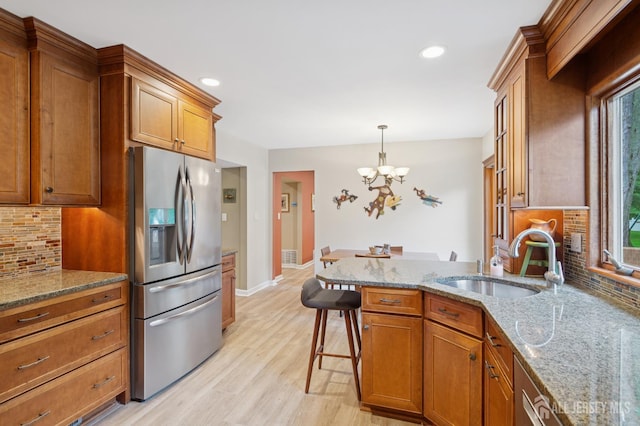 6 Steven Rd, South Brunswick, NJ 08824 - kitchen featuring stainless steel fridge with ice dispenser, brown cabinetry, light wood-style flooring, a chandelier, and recessed lighting