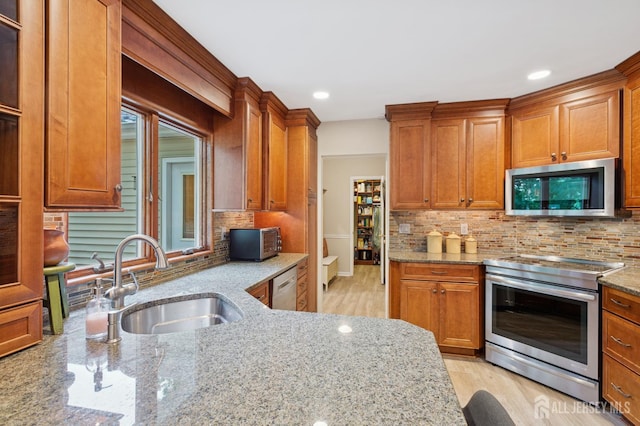 6 Steven Rd, South Brunswick, NJ 08824 - kitchen with appliances with stainless steel finishes, light stone countertops, tasteful backsplash, brown cabinetry, and recessed lighting
