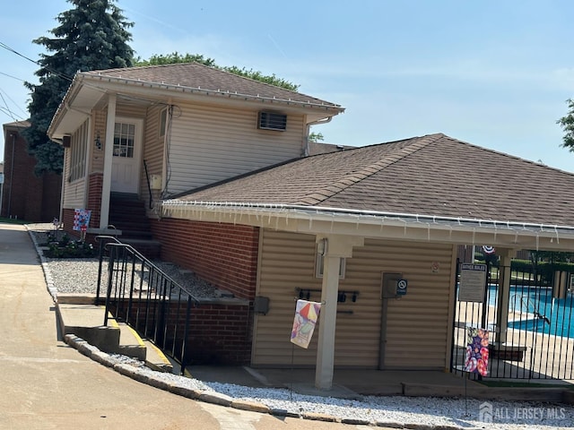 66 Fox Rd Unit 10A, Edison, NJ 08817 - view of front of home featuring roof with shingles, stairs, and a community pool