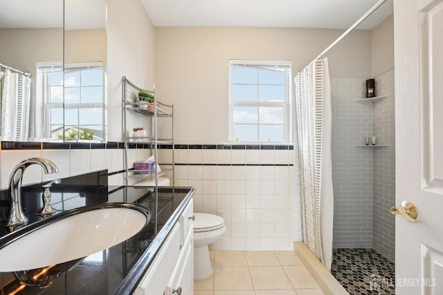 415 Lorillard Ave, Union Beach, NJ 07735 - bathroom with toilet, tile walls, a tile shower, and tile patterned flooring