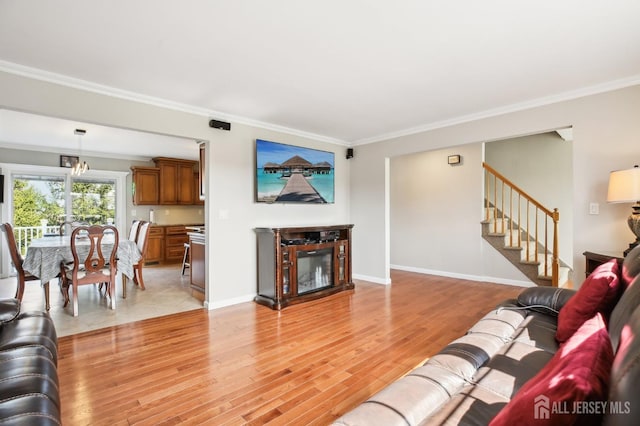 415 Lorillard Ave, Union Beach, NJ 07735 - living area with a glass covered fireplace, light wood-style flooring, baseboards, ornamental molding, and stairway