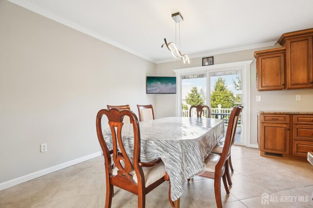 415 Lorillard Ave, Union Beach, NJ 07735 - dining area with baseboards, ornamental molding, and light tile patterned floors