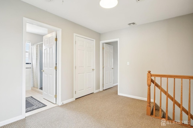 415 Lorillard Ave, Union Beach, NJ 07735 - hallway featuring baseboards, carpet, visible vents, and an upstairs landing