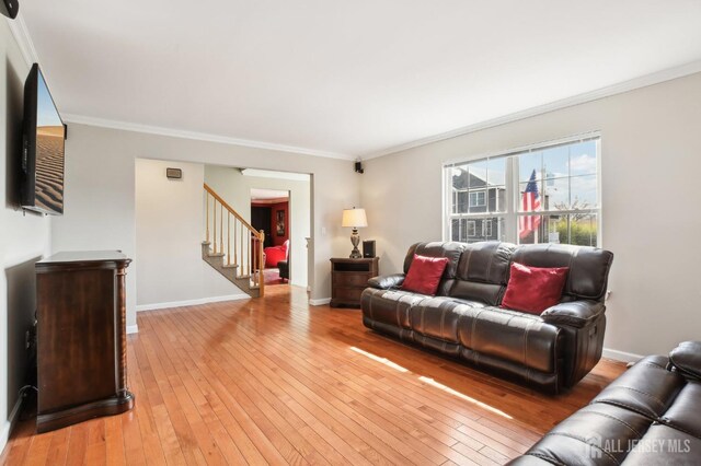 415 Lorillard Ave, Union Beach, NJ 07735 - living area featuring crown molding, baseboards, stairway, and light wood-style flooring