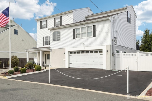 415 Lorillard Ave, Union Beach, NJ 07735 - view of property featuring stucco siding, aphalt driveway, a garage, and fence
