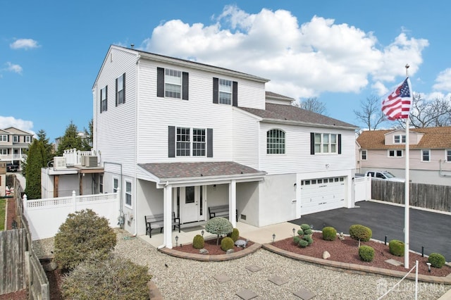 415 Lorillard Ave, Union Beach, NJ 07735 - view of front of home with covered porch, fence, driveway, and a garage