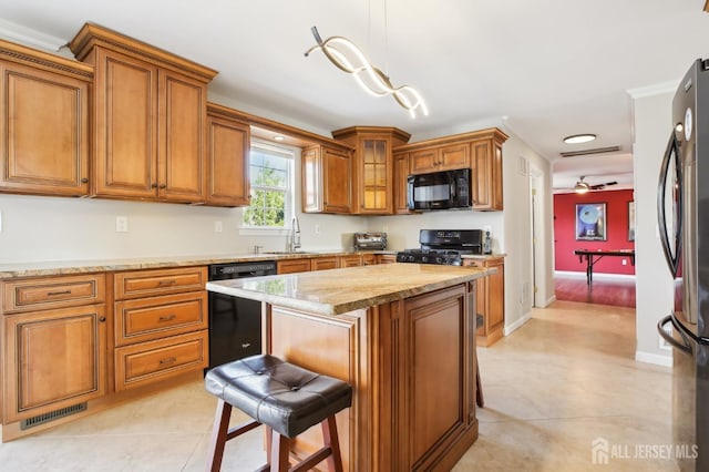 415 Lorillard Ave, Union Beach, NJ 07735 - kitchen with visible vents, a sink, brown cabinets, and black appliances